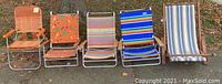 Photo showing the full set of five vintage folding beach chairs in different colors and patterns arranged in a row outdoors on grass.