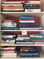 Shelf filled with various books including titles on history, biographies, and regional subjects