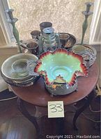 Overview of all lot items displayed on round wooden end table