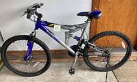 Full side view of the Mongoose XR 200 bicycle showing frame, wheels, suspension and seat