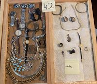 Full lot overview showing wristwatches, chains, bracelets, earrings, rings, and pendants arranged in wooden tray.