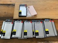 Photo showing all nine iPhone XR cases including one pink silicone case outside the box and eight boxed YOHURO Super Slim Stylish Choice cases.