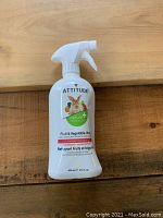 Front view of Attitude Fruit & Vegetable Wash bottle on wooden surface.