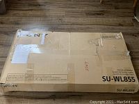 Sealed cardboard box with Sony SU-WL855 model number marked, box is intact with minor wear.