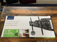 Box front showing Insignia brand and specifications for TV wall mount sized for 47-80 inch TVs and full-motion mount.