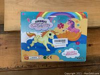 Box front showing colorful unicorn egg design, age 3+ indication, contains 48 pieces and safety warning not to swallow.