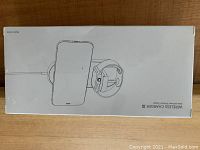 Box showing front side with illustration of charging pad holding an iPhone and an Apple Watch.