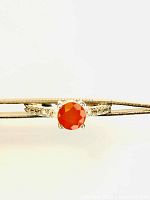 Front view of the ring with orange diamond cut carnelian and cubic zirconia accents on silver band, held by ring clamp.
