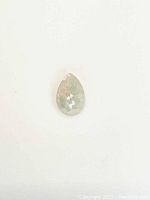 Faceted pear cut Ethiopian opal on white background showing size and shape.