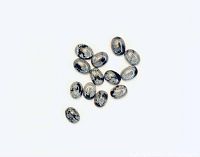 13 oval snowflake obsidian cabochons arranged loosely showing their shape and snowflake pattern.