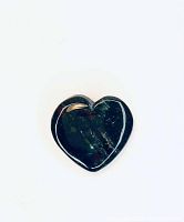 Close-up of the polished heart-shaped agate gem showing smooth carved surface and natural color variations.