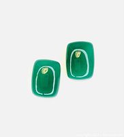 Two vivid bright green onyx stones, smooth, polished, rounded rectangle shape.
