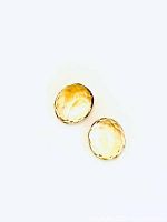 Two oval cut golden citrine gemstones displayed on white background