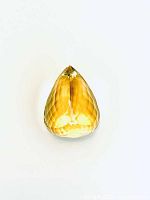 Top view of pear cut citrine gemstone showing faceted surface