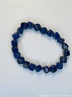 Blue lapis lazuli bracelet beads cube-shaped on elastic cord