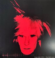Close up of the lithograph showing Andy Warhol's red and black stylized self portrait.