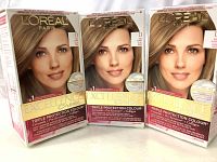 Front view of three boxes of L'Oreal Excellence Creme hair dye in Dark Blonde D shade, showing model and branding.