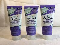 Three new tubes of St. Ives Firming Mineral Clay Mask shown standing upright, showing front labels.