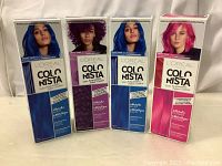 Four new L'Oreal Colorista hair dye boxes in Metallic Blue, Fuchia, and Orchid shades, front view showing product branding and hair color results.