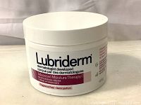 Front view of the white Lubriderm cream jar with brand and product name visible.