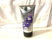 Front view of the silver tube labeled Olay Regenerist Retinol 24 Facial Cleanser 150ml with purple bubble graphics and black flip cap.