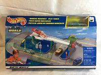 Front view of original box with intact plastic window showing the green Hot Wheels car inside and artwork of the Radical Roadway play track.