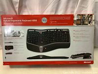 Front of product box showing Microsoft Natural Ergonomic Keyboard 4000 branding, ergonomic keyboard image, and description of ergonomic design.