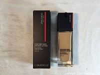 Photo of the Shiseido foundation in original box and bottle showing front of packaging with product name and size.