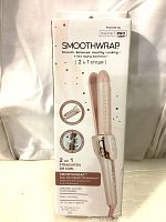 Front side of the SmoothWrap 2 in 1 Hair Styler box showing product image and main features: 2 in 1 styling, ceramic coated plate, dual voltage.