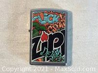 Front view of stainless steel Zippo lighter with colorful graffiti decal featuring the Zippo name and various artistic elements.