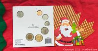 Front and back views of the 2010 Royal Canadian Mint uncirculated coin set showing all the included coins displayed in holiday-themed packaging with Santa Claus illustration.