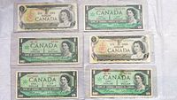 Front sides of six Canadian one dollar bills showing Queen Elizabeth II and varying designs