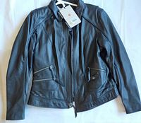 Front view of black leather jacket laid flat showing zip closure, pockets, collar and tags