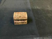 First mini treasure chest showing top and front carved details