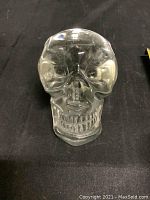 Frontal view showing skull facial details, clear transparent glass with no visible imperfections.