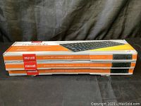 Side view stack of the three Maxell slim wireless keyboard boxes showing branding and product features on the boxes.