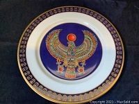 Photo of the front of the Horus Falcon collectors plate with detailed image of the colorful falcon and gold hieroglyph border.