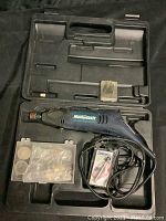Mastercraft rotary tool drill and accessories in open black molded plastic carrying case. Includes sanding discs, drill bits, and an electrical cord attached to the tool.
