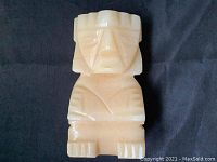 Front view of the hand carved yellow marble Aztec figure bookend showing detailed facial and body carving with a cream-yellow tone.