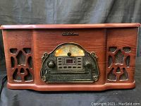 Front view of Electrohome stereo radio record player in wooden cabinet with illuminated dial and control knobs.