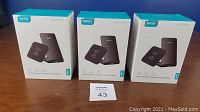 Three boxed Choetech wireless charging pads and stands grouped together