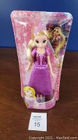 Two Disney Princess Royal Shimmer Rapunzel dolls in sealed packaging with pink glitter backgrounds and character art