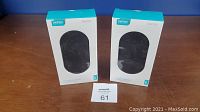 Two sealed boxes of Chotech T535-S dual fast wireless chargers on wooden surface