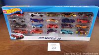 Front view of the unopened Hot Wheels 20 car gift set showing all cars packed inside clear plastic display in blue box.