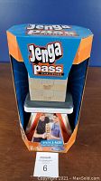 Front view of Jenga Pass Challenge game in packaging showing the blocks stacked with the Hasbro logo and game title.