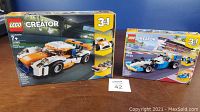 Photo showing closed Lego Creator 3-in-1 Sunset Track Racer set box (31089) with car images and age recommendation 7+. The box has full packaging visible.