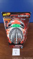 Front view of Nerf Fire Vision football and goggles in packaging