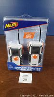 Front view of packaged Nerf Walkie Talkies showing two walkie talkies, branding, and range details.