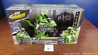 Boxed Kid Galaxy R/C Motorcycle toy showing front and side package views with remote control visible inside.