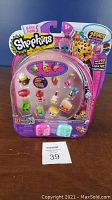 Two Shopkins Season 5 packages, each containing 12 figures and 2 bonus Shopkins, with colorful sealed blister packs.